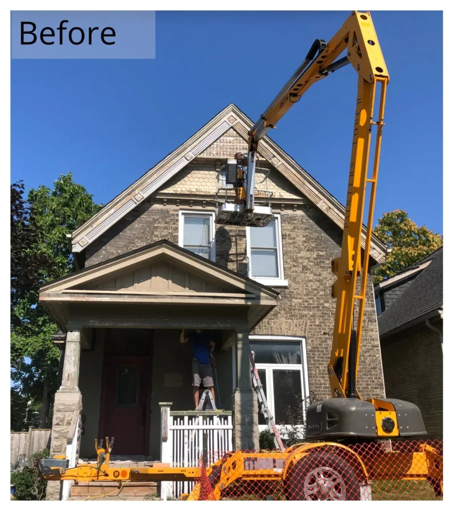 Boom lift used to reach a tall historical home exterior