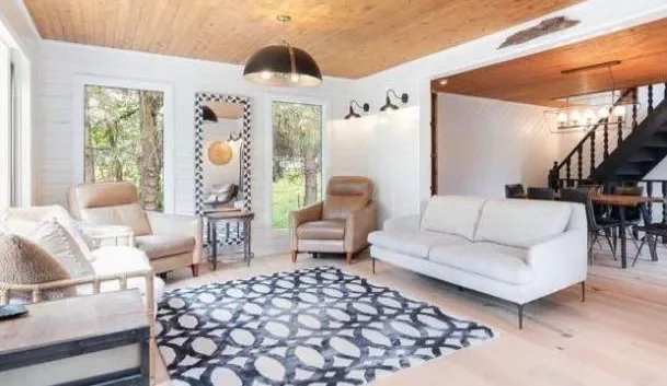 Bright painted living room with white walls and wood ceiling